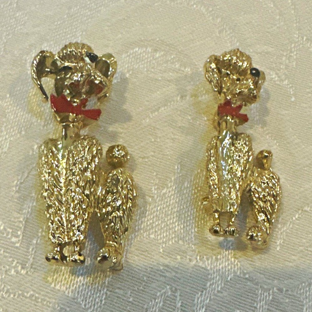 Vintage gold-tone textured poodle brooches with red enamel rhinestone collars.